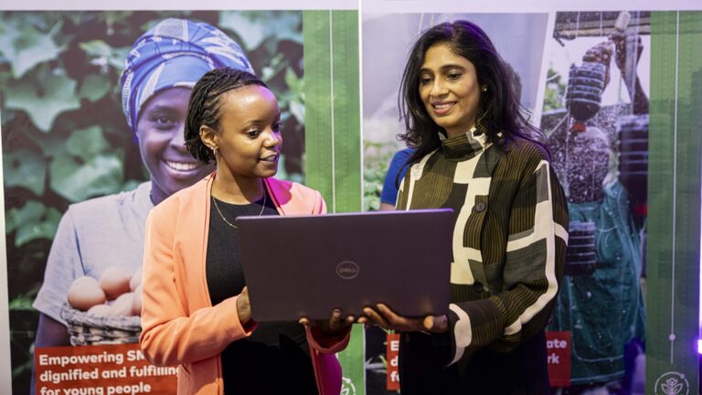 Ms. Michelle Gathigi (left) the Director of Operations for Spatial Collective Limited is taken through the application process of the Agribusiness Challenge Fund by the Mastercard Foundation Fund for Resilience and Prosperity Engagement Partner Mrs. Smita Sanghrajka (right) during the launch of the fund.